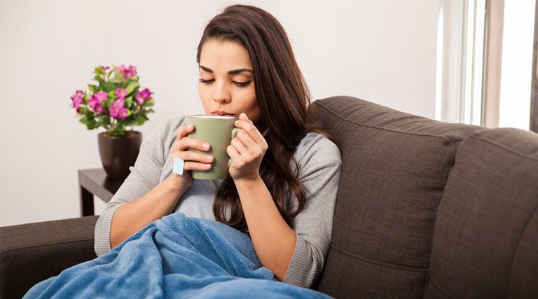 woman on sofa with tea