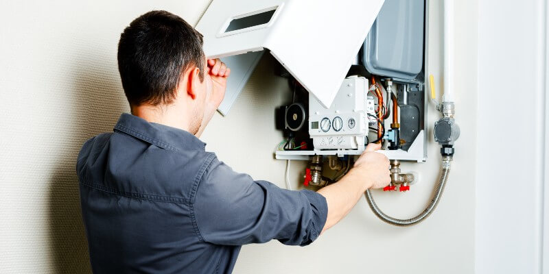 man checking boiler