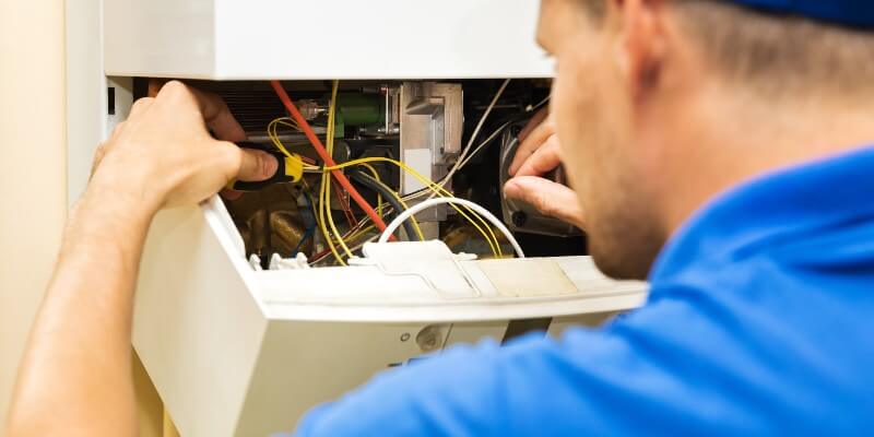 plumber fixing boiler