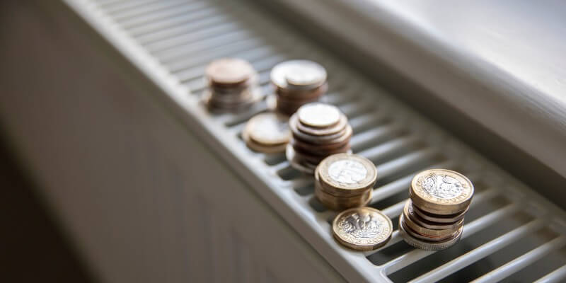 money on radiator as energy bills are rising